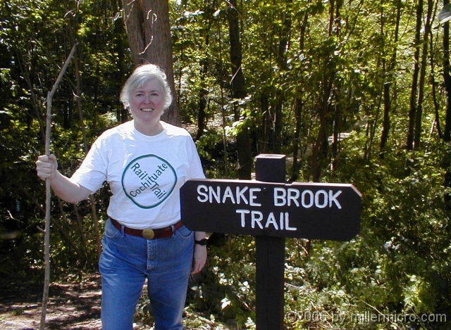 010905CSPCRTshirt PART 4 - Snake Brook Trail.
CRT activist Jill Miller shows off a CRT-shirt -- and one of Cochituate State Park's 