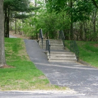 050514StairsAndRamp Also in Saxonville, at 500 Old Connecticut Path near the CRT, this combination of steps and a ramp shows the way to welcome bicycles and wheelchairs back to office buildings. Alternate transportation depends upon willing users, but also upon support from towns and businesses.