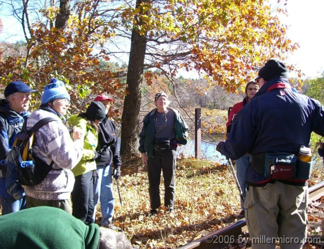 061026RockyNarrows3 At the railroad bridge across the Charles River, Bernie at right, back to us) explains.